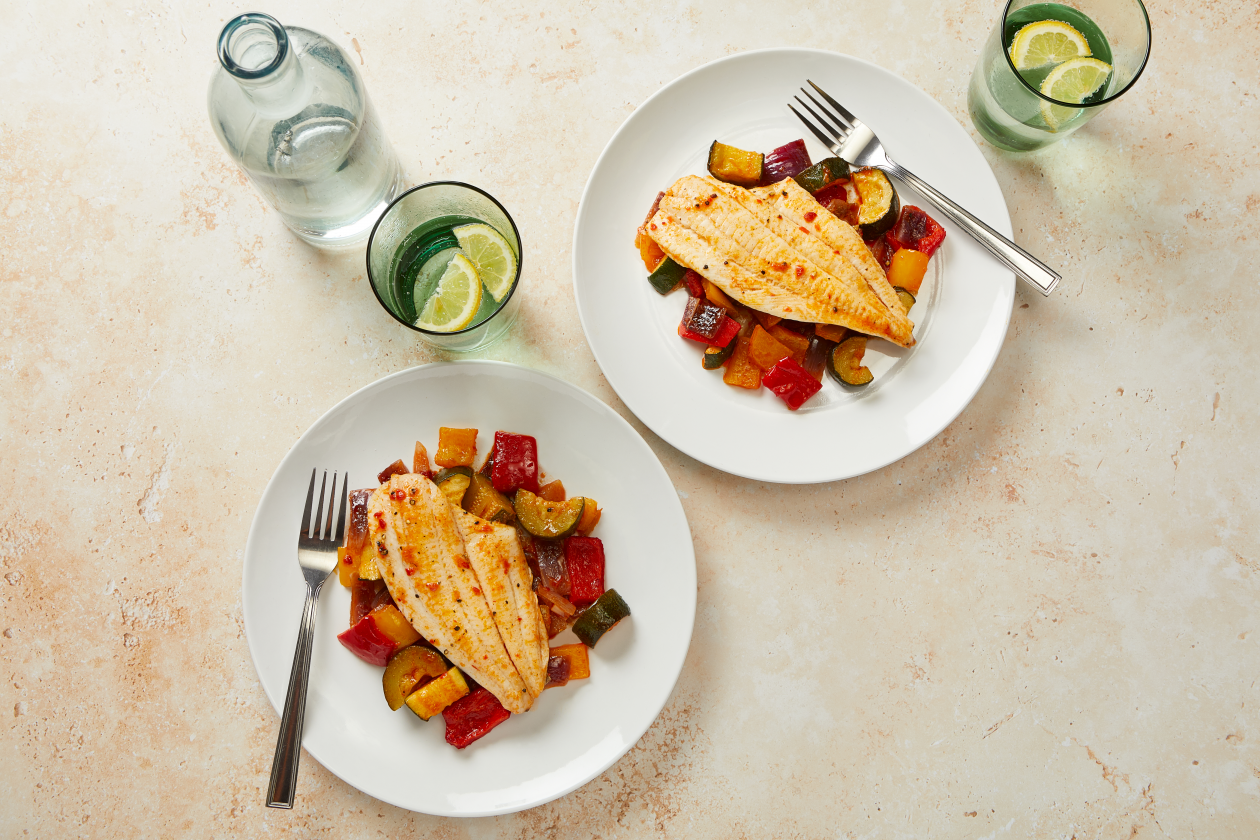 A photograph of Plaice and roasted vegetables with harissa