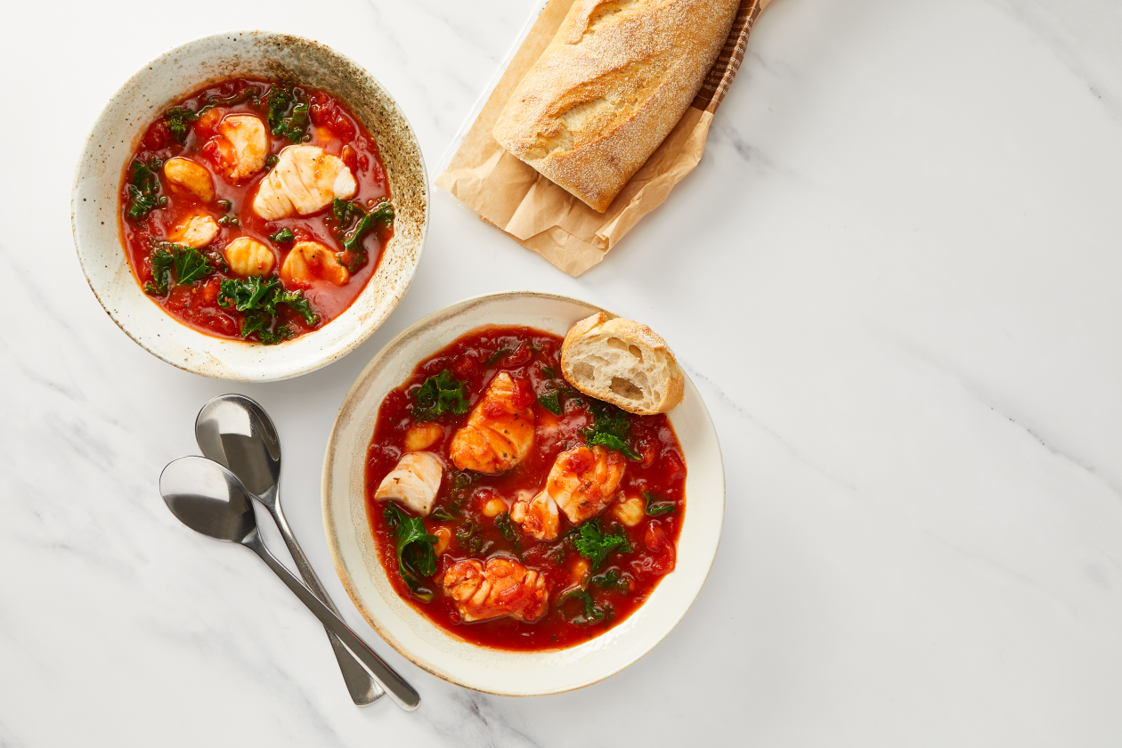 A photograph of Italian-style Fish Stew with Kale & Gnocchi